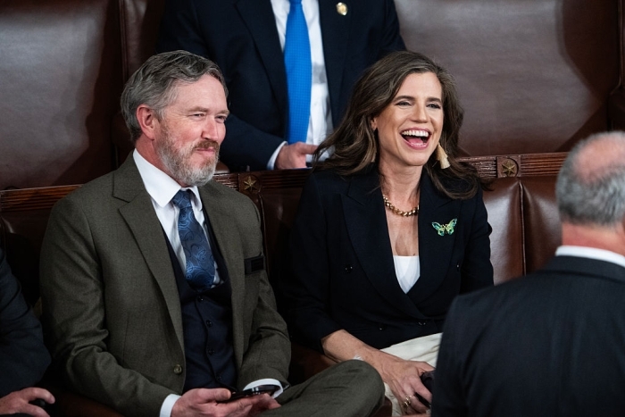 Nancy Mace seated and laughing during a formal political event
