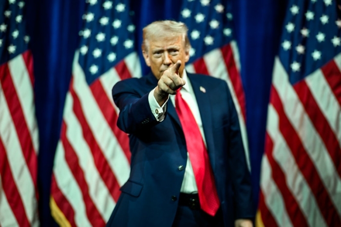 Man pointing in front of American flags during federal probe on 86 47 in National Mall Man pointing in front of American flags during federal probe on 86 47 in National Mall
