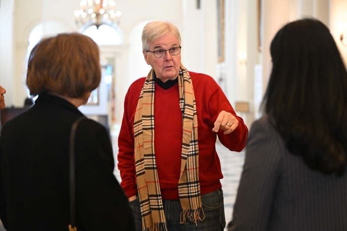 Texas Lt Governor Dan Patrick talking with people inside a state house hallway