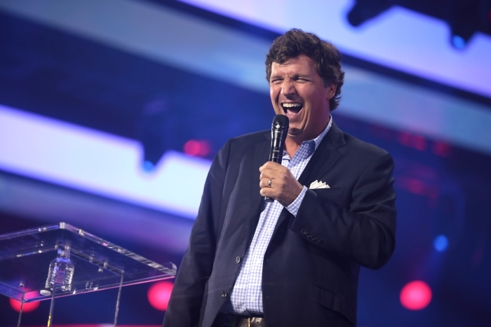 Tucker Carlson speaking with attendees at the 2022 AmericaFest at the Phoenix Convention Center in Phoenix, Arizona.