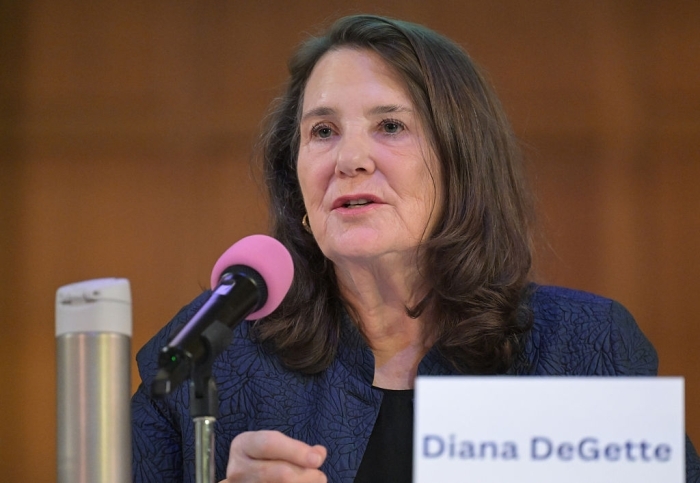 An older Denver Democrat speaking at a podium with a pink microphone, likely before being unseated.
