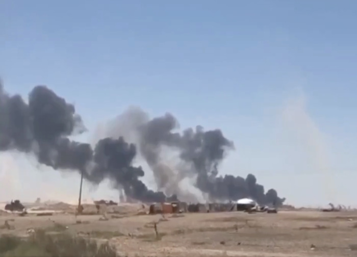 Thick black smoke rising from a burning facility after an Iranian strike on Jordan Base.